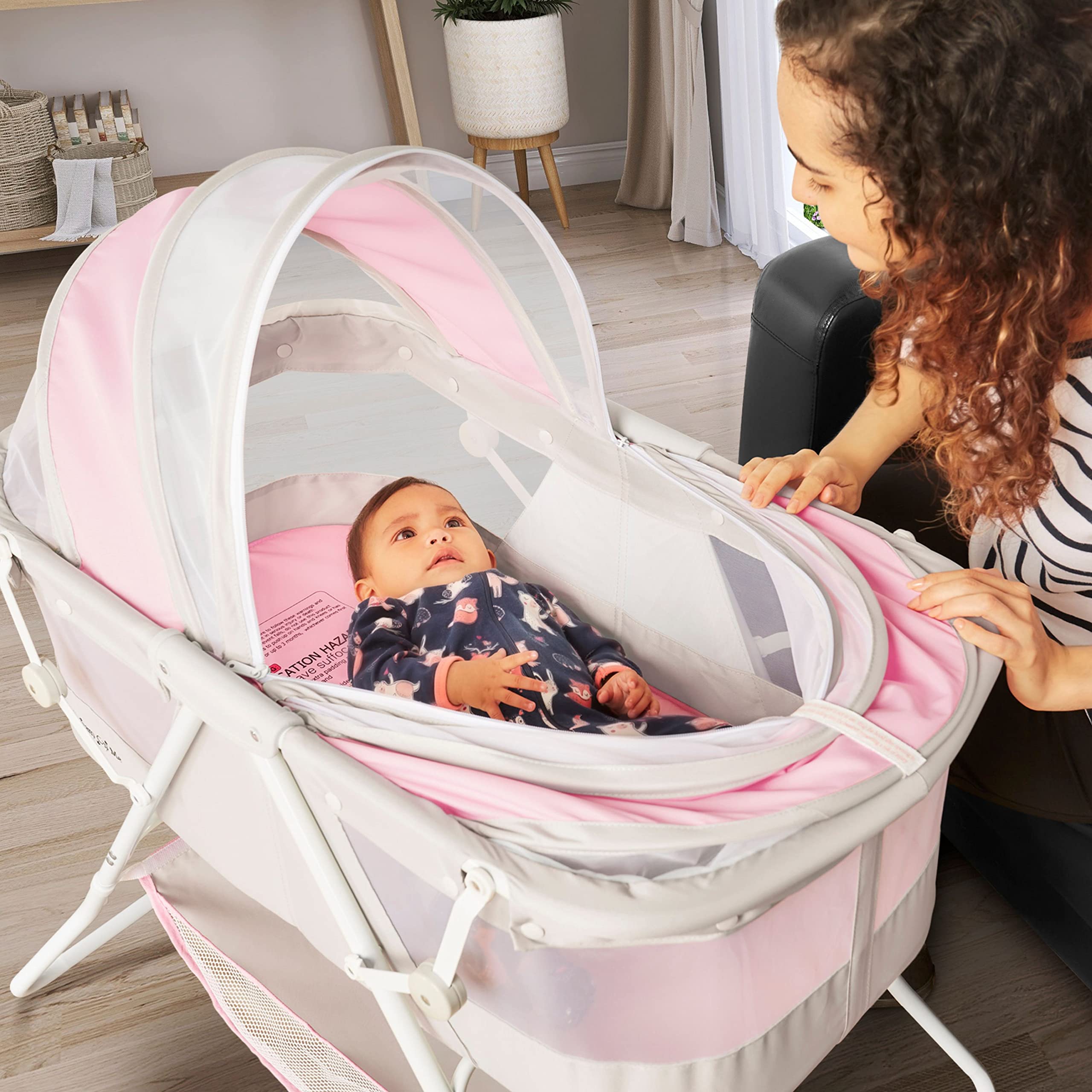 Dream On Me Karley Baby Bassinet in Grey and Pink, Lightweight Portable, Quick Fold and Easy to Carry , Adjustable Double Canopy, Indoor and Outdoor with Large Storage Basket.